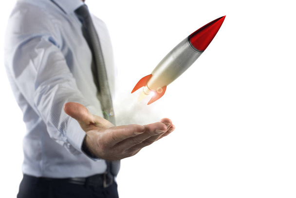 Businessman holding a small rocket. - Photo, Image
