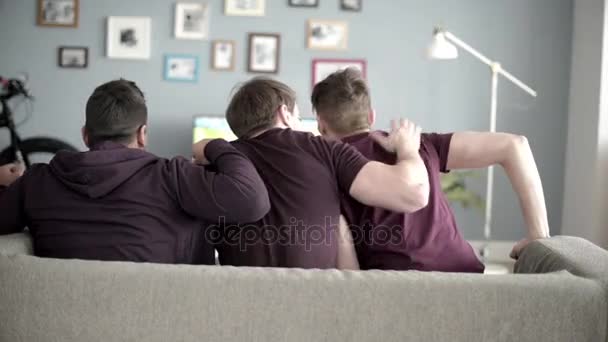 Vrienden kijken naar voetbalwedstrijd op de Bank  - Video