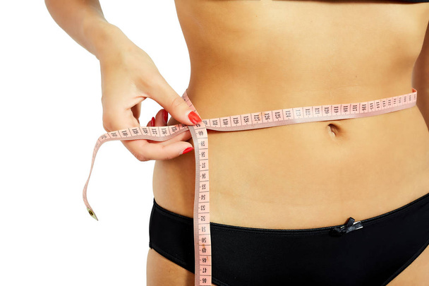 Young attractive woman measuring her hips - Fotó, kép