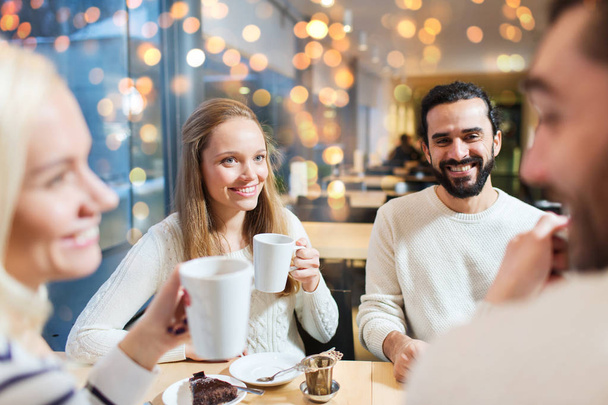 happy friends drinking tea at cafe - Фото, изображение