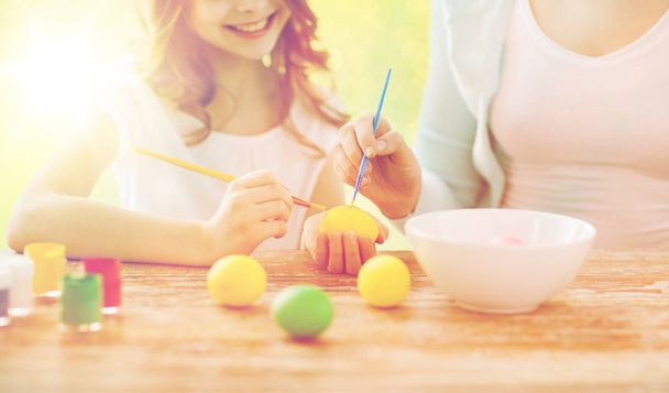 close up of family coloring easter eggs - Фото, зображення
