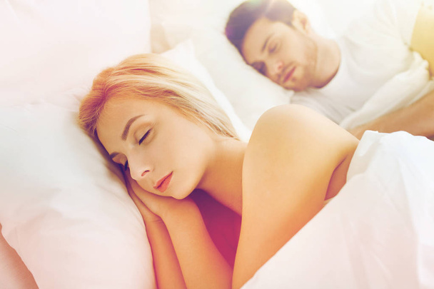 happy couple sleeping in bed at home - Photo, image