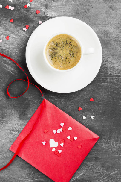 Espresso coffee in a white cup, love letter on a dark background. Top view. Food background - Foto, imagen