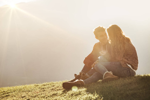 Young couple sitting on the grass - Zdjęcie, obraz