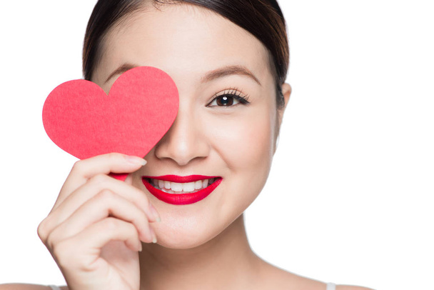 Cute attractive young woman with red heart. Valentine's day art portrait. Perfect make up - Photo, Image
