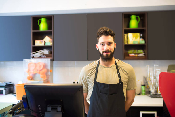 A young barista man  - Foto, afbeelding