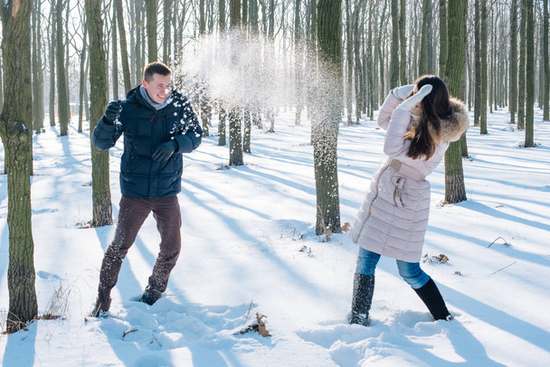 couple having fun in snowy park - Фото, зображення