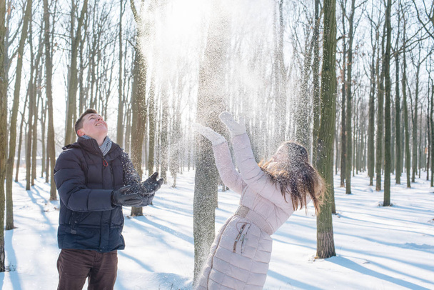 couple having fun in snowy park - 写真・画像