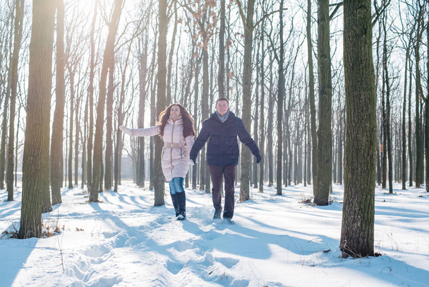 couple having fun in snowy park - Foto, afbeelding