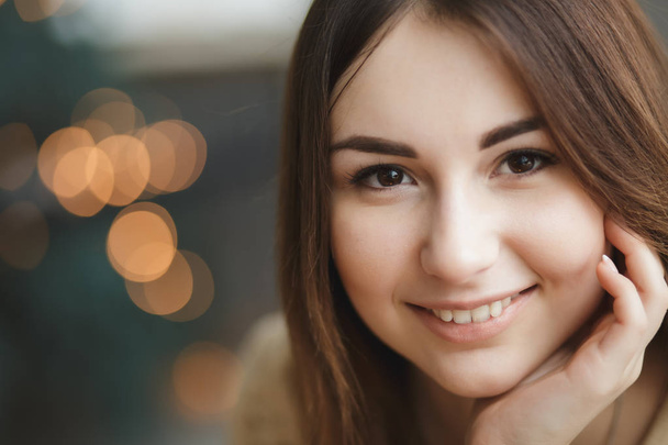 Close-up face of lovely woman, golden bokeh background - Фото, зображення