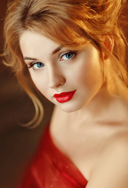 Close-up portrait of a beautiful young blond woman with red lips - 写真・画像