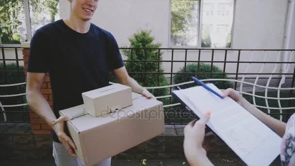 Man Courier Brings Order to Customer, Gives Pen and Paper to Sign and Client Girl Takes Order and Runner Leaves. - Video, Çekim
