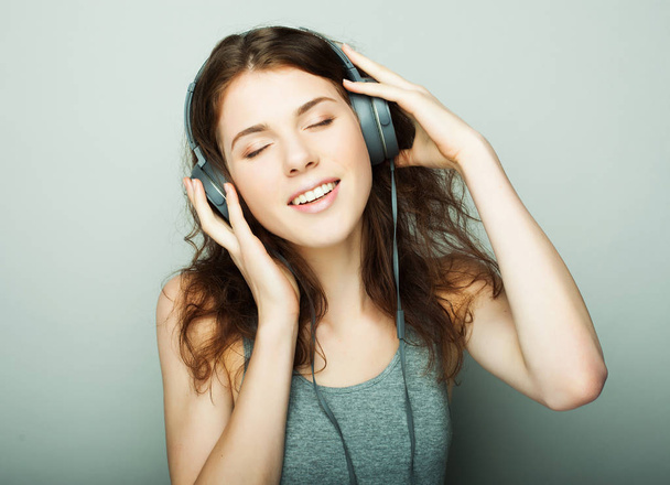lifestyle and people concept: young woman with headphones listening music. - 写真・画像
