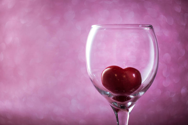red heart in a glass on  blurred background. - Фото, зображення
