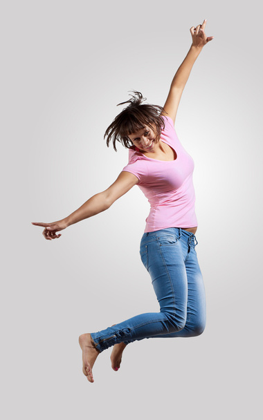 Young woman dancing and jumping - Fotó, kép