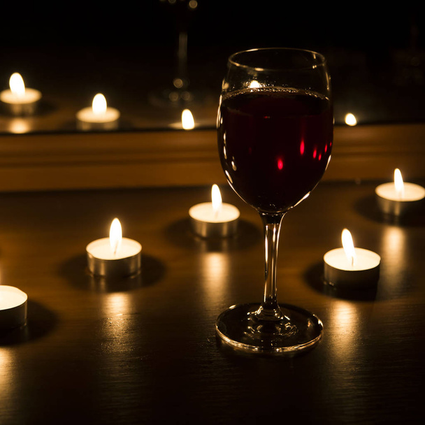 candles and a glass of wine home evening - Zdjęcie, obraz
