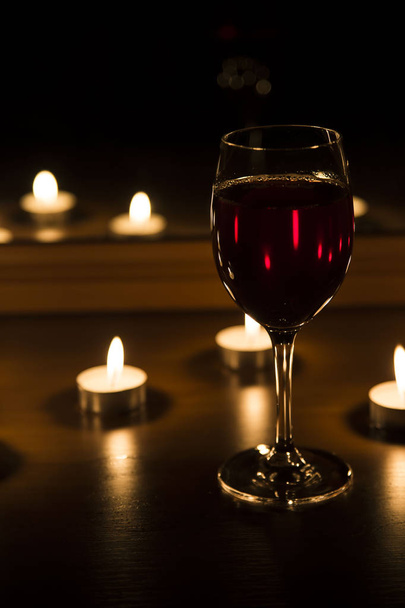 candles and a glass of wine home evening - Foto, Imagem