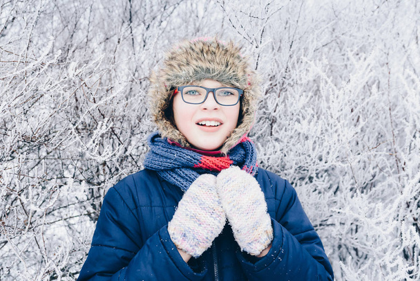 Winter fun - Portrait of Happy child girl on a winter walk in nature - Photo, Image