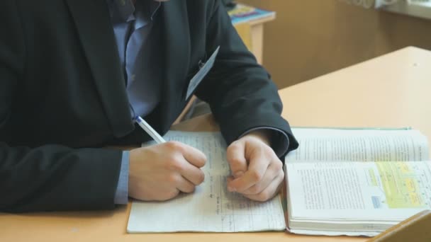 Pupil writes the text in exercise book on lesson - Кадры, видео