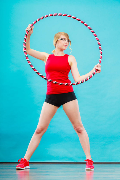 Fit woman with hula hoop doing exercise - Zdjęcie, obraz