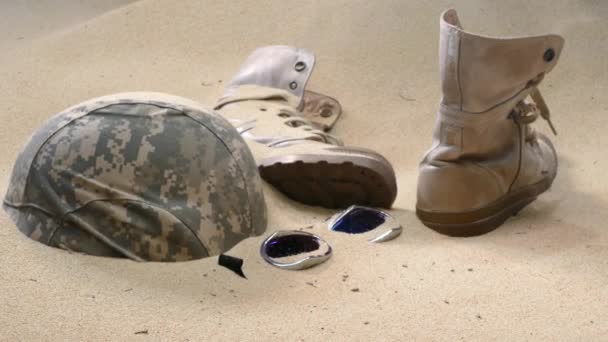 soldier hat  boots and sand glass in the desert - Footage, Video