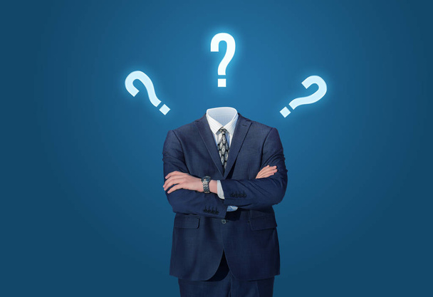 Businessman standing without head with drawing question marks. - Photo, Image