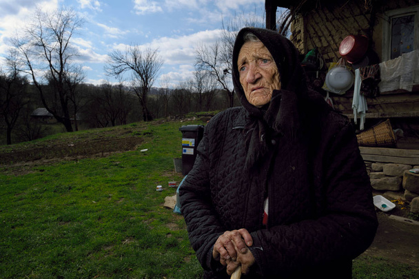 Old woman in head scarf standing - Fotó, kép