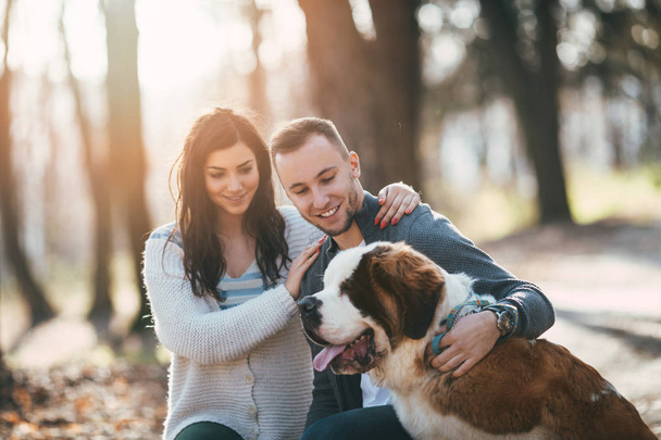 Couple and their dog in forest - Photo, image