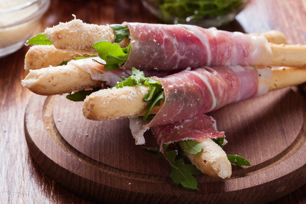 Italian grissini with ham prosciutto, mozzarella and arugula - Φωτογραφία, εικόνα