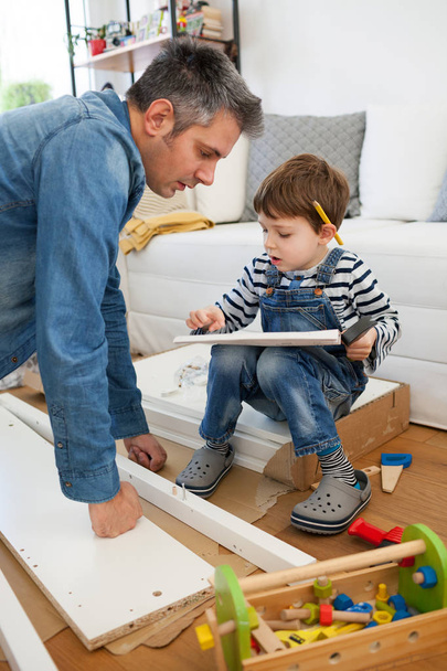 Father and son assembling furniture  - Foto, Imagem