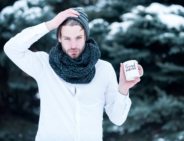 handsome man with morning cup in winter outdoor - Фото, изображение
