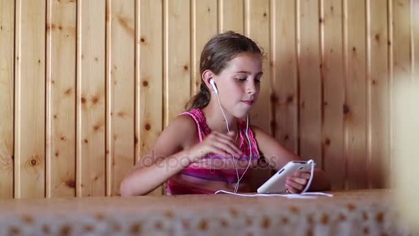 Girl listens to music and sings a song - Footage, Video