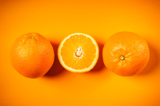 juicy oranges on an orange background - Photo, Image