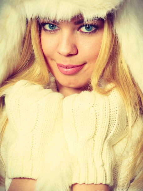 Blonde woman with fur cap. - Zdjęcie, obraz