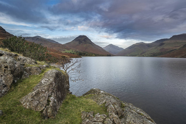 Beautiful sunset landscape image of Wast Water and mountains in  - Photo, Image