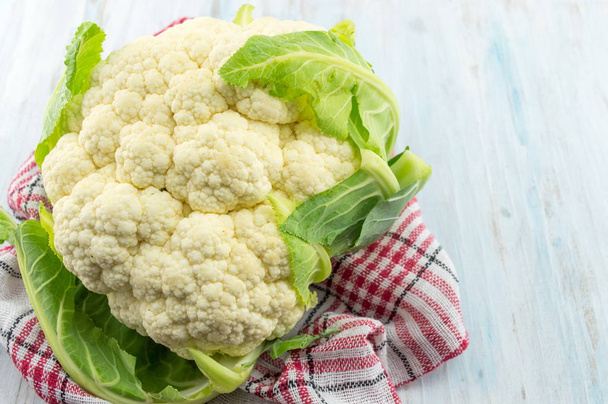 Raw cauliflower on a wooden table - Photo, Image