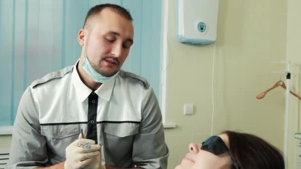 In dental office doctor conducts a survey of female patients. - Video, Çekim