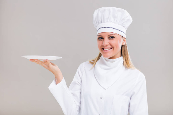 Female chef holding plate - Foto, Imagem