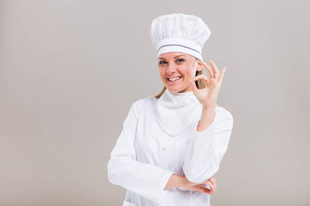 Beautiful female chef showing ok sign - Fotografie, Obrázek