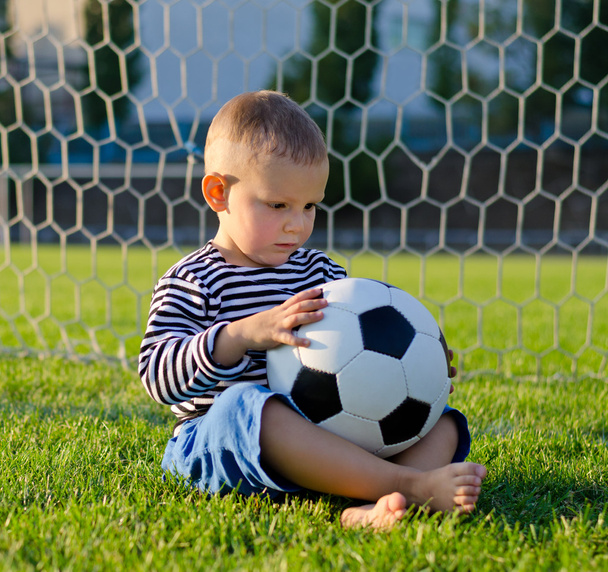 Little boy in the goal with his soccer ball - Zdjęcie, obraz