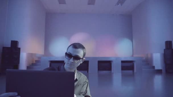 Guy enjoys a laptop being alone on the dance floor - Video, Çekim