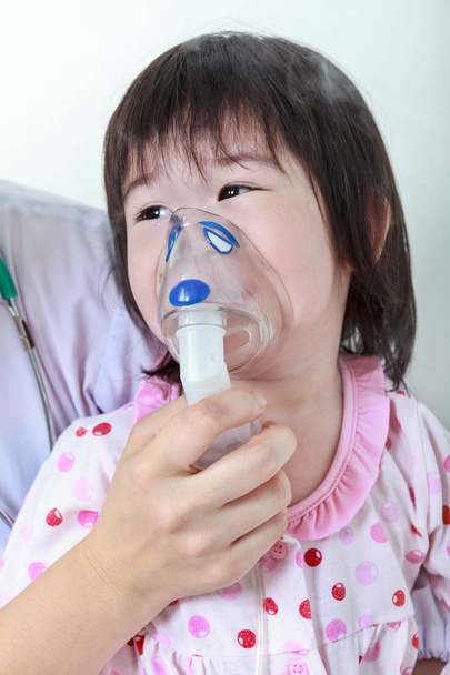 Asian girl having respiratory illness helped by doctor at hospital room. - Photo, Image