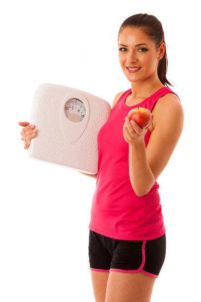 Woman holding scale and apple for healthy lifestyle and nutritio - Φωτογραφία, εικόνα