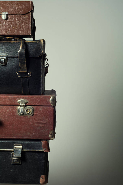 Background stack of old suitcases form a tower - Фото, изображение