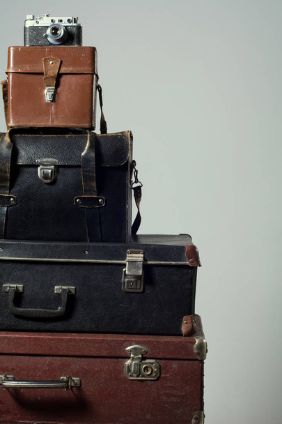 Stack of vintage shabby suitcases and camera - Photo, Image