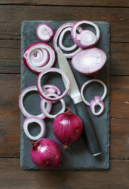Red onions on a wooden table - Photo, Image