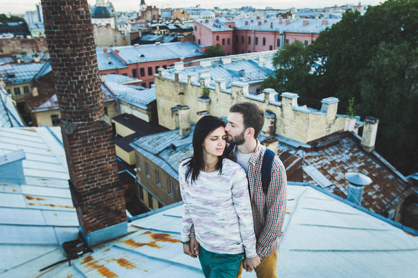 couple walking on the roofs of St. Petersburg.  - Фото, зображення