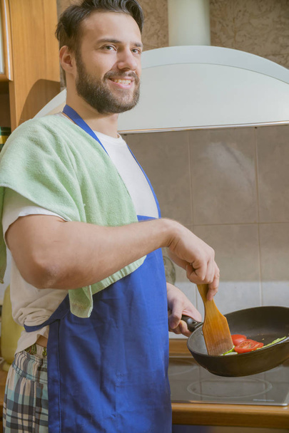 a man cooks in the kitchen - Фото, зображення