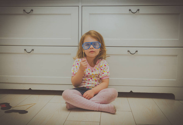 girl playing in the masquerade, tries on glasses - Photo, image