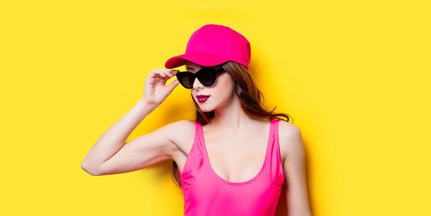 Elegant brunette woman in pink swimsuit and fashion cap. Sexy la - Photo, Image